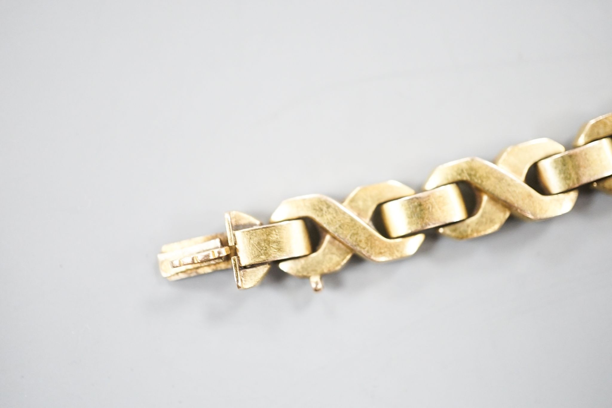 A modern continental yellow, metal, ruby, emerald and diamond set bracelet, 18.3cm, gross weight 14.5 grams.